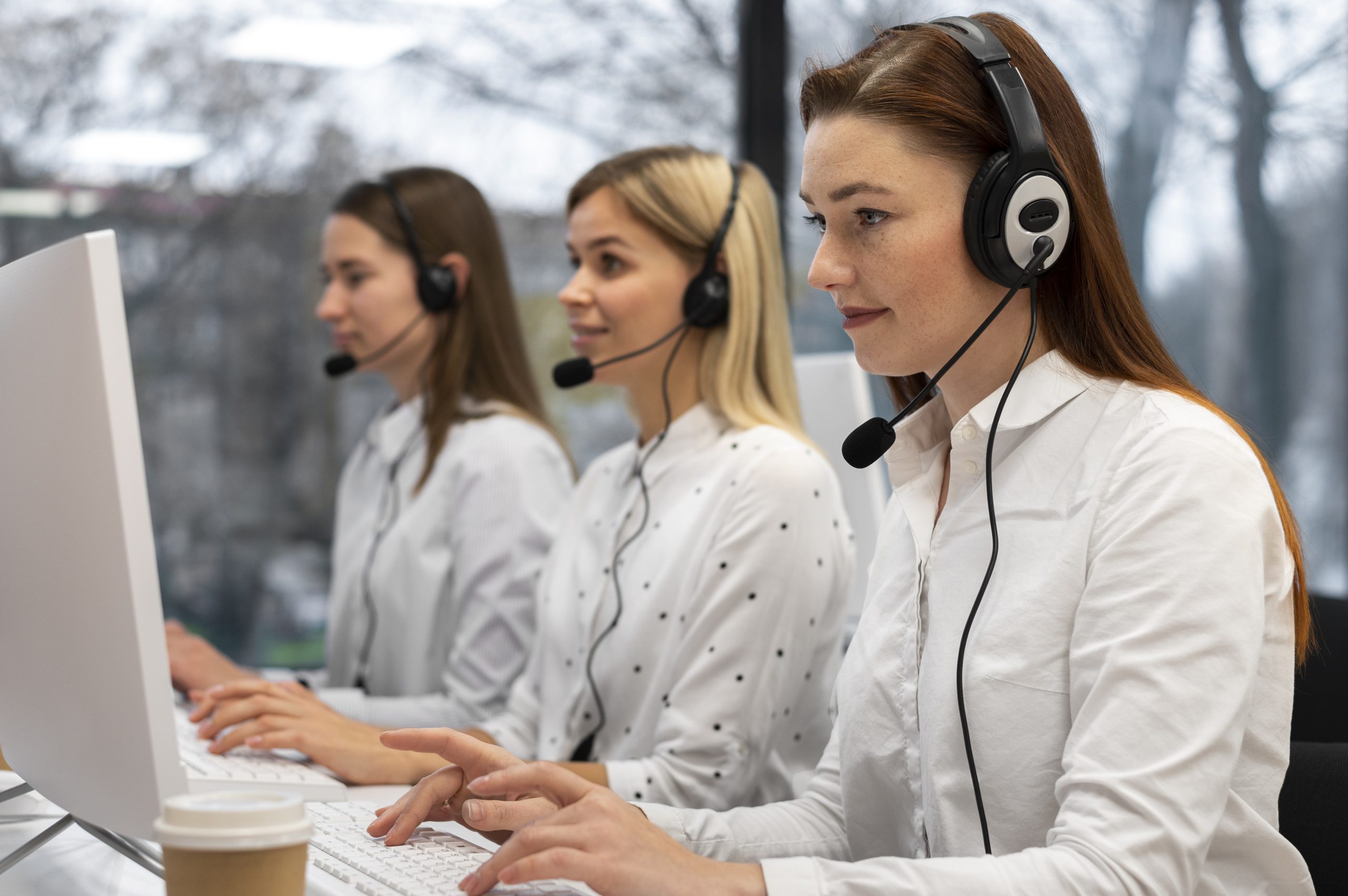 colleagues-working-together-call-center-with-headphones (1)